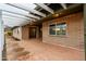 Spacious covered patio with brick accents, wrought iron security door, and ample space for seating at 7605 N 45Th Dr, Glendale, AZ 85301