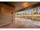 Covered patio area with brick wall and white pergola offering outdoor living and entertaining at 7605 N 45Th Dr, Glendale, AZ 85301