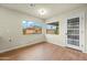 Bright room featuring hardwood floors and two windows showing the backyard at 7605 N 45Th Dr, Glendale, AZ 85301