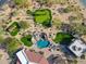 Aerial view of the backyard showcasing the putting green, pool, and outdoor living areas at 7788 E Morning Vista Ln, Scottsdale, AZ 85266