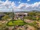 Aerial view of the property with a putting green, pool, playground, and desert landscaping at 7788 E Morning Vista Ln, Scottsdale, AZ 85266
