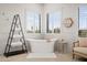 Bright bathroom with standalone tub, natural light, and minimalist decor creates a relaxing spa-like atmosphere at 7788 E Morning Vista Ln, Scottsdale, AZ 85266