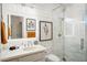Bright bathroom featuring a shower with marble tiling, modern fixtures, and shiplap walls at 7788 E Morning Vista Ln, Scottsdale, AZ 85266