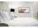 Comfortable bedroom featuring a white iron bed frame and unique wall art at 7788 E Morning Vista Ln, Scottsdale, AZ 85266