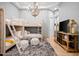 Bright bedroom with stylish bunk beds, patterned rug, and a decorative chandelier at 7788 E Morning Vista Ln, Scottsdale, AZ 85266