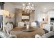 Elegant dining room featuring a rustic wooden table, crystal chandelier, and decorative shelving at 7788 E Morning Vista Ln, Scottsdale, AZ 85266