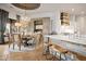 Stylish dining area open to the kitchen, featuring a chandelier and custom cabinetry at 7788 E Morning Vista Ln, Scottsdale, AZ 85266