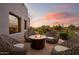 Cozy outdoor seating area with a fire pit, ideal for relaxing evenings with desert views at 7788 E Morning Vista Ln, Scottsdale, AZ 85266