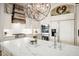 Open kitchen with stainless steel appliances, quartz countertops, and a wood-paneled range hood at 7788 E Morning Vista Ln, Scottsdale, AZ 85266