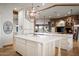 Spacious kitchen with dual islands, stone fireplace, and natural light streaming through large windows at 7788 E Morning Vista Ln, Scottsdale, AZ 85266
