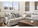 Comfortable gray couch with an assortment of pillows and natural lighting at 7788 E Morning Vista Ln, Scottsdale, AZ 85266