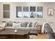 Comfortable living room featuring a large gray sofa and bright natural light through plantation shutters at 7788 E Morning Vista Ln, Scottsdale, AZ 85266