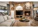 Living room featuring a stone fireplace, and entertainment center, perfect for relaxation at 7788 E Morning Vista Ln, Scottsdale, AZ 85266