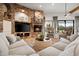 Comfortable living room featuring a stone fireplace, and large windows, creating an inviting space at 7788 E Morning Vista Ln, Scottsdale, AZ 85266
