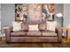 Comfortable living room featuring a leather sofa, hardwood floors, and stylish artwork at 7788 E Morning Vista Ln, Scottsdale, AZ 85266