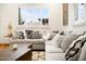 Well-lit sitting area with sectional couch, pillows, and shuttered windows at 7788 E Morning Vista Ln, Scottsdale, AZ 85266