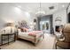 Spacious main bedroom featuring a fireplace, crystal chandelier, and French doors to the backyard at 7788 E Morning Vista Ln, Scottsdale, AZ 85266