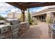 Built-in outdoor grill with stainless steel appliances and stone accents blends seamlessly with the patio's desert landscape at 7788 E Morning Vista Ln, Scottsdale, AZ 85266