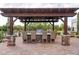 Outdoor kitchen features a built-in grill, counter seating, and a pergola for shade at 7788 E Morning Vista Ln, Scottsdale, AZ 85266
