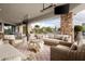 Expansive covered patio with multiple seating areas, offering a luxurious outdoor living experience with stunning views at 7788 E Morning Vista Ln, Scottsdale, AZ 85266
