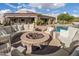 Inviting outdoor space with a stone fire pit and plush seating, ideal for entertaining guests at 7788 E Morning Vista Ln, Scottsdale, AZ 85266