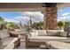Comfortable outdoor seating area near a sparkling pool with a rock waterfall and desert landscaping at 7788 E Morning Vista Ln, Scottsdale, AZ 85266