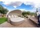 Relaxing outdoor daybed nestled on a brick patio, surrounded by desert landscape at 7788 E Morning Vista Ln, Scottsdale, AZ 85266