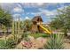 Charming backyard playground with a wooden playset, slide, and climbing features at 7788 E Morning Vista Ln, Scottsdale, AZ 85266