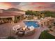 Stunning backyard oasis with a pool, fire pit, covered patio, and playground, perfect for entertaining at 7788 E Morning Vista Ln, Scottsdale, AZ 85266