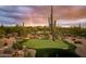 Backyard putting green surrounded by desert landscaping, creating a tranquil and private setting at 7788 E Morning Vista Ln, Scottsdale, AZ 85266