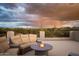 Rooftop deck featuring a cozy seating area with a fire pit and scenic mountain views at 7788 E Morning Vista Ln, Scottsdale, AZ 85266