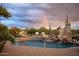 Backyard pool with rock slide, waterfall, and lounge area, perfect for outdoor fun at 7788 E Morning Vista Ln, Scottsdale, AZ 85266