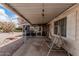 Enjoy the outdoors on this covered patio, featuring a swing and views of the landscaped backyard at 8323 E Deep Canyon Ct, Mesa, AZ 85208
