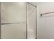 Bathroom shower with translucent sliding glass door and wood towel rack at 8323 E Deep Canyon Ct, Mesa, AZ 85208