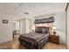 Comfortable bedroom featuring a wood bedframe with nightstands and lamps at 8323 E Deep Canyon Ct, Mesa, AZ 85208