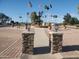 A stunning fountain, flags, and lush greenery creates a striking focal point at the heart of the community at 8323 E Deep Canyon Ct, Mesa, AZ 85208