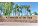 An inviting community sign, Fountain of the Sun, is framed by lush palm trees and meticulously maintained landscaping at 8323 E Deep Canyon Ct, Mesa, AZ 85208
