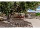 Charming home with a covered parking, rock landscaping, and mature trees at 8323 E Deep Canyon Ct, Mesa, AZ 85208