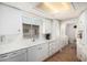 Bright and airy kitchen with white cabinetry and ample counter space at 8323 E Deep Canyon Ct, Mesa, AZ 85208