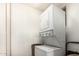 Efficient laundry area features a stacked washer and dryer, maximizing space and convenience at 8323 E Deep Canyon Ct, Mesa, AZ 85208