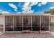 A screened-in porch offers an outdoor living space with plenty of room to relax and enjoy beautiful blue skies at 8323 E Deep Canyon Ct, Mesa, AZ 85208