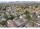 Aerial view of a residential neighborhood with well-manicured lawns and community pool and mountain views at 9015 E Altadena Ave, Scottsdale, AZ 85260