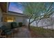 Secluded backyard patio area, shaded by mature trees, offers a tranquil outdoor retreat at 9015 E Altadena Ave, Scottsdale, AZ 85260