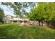 Large backyard with a pool and mature trees surrounding it at 9015 E Altadena Ave, Scottsdale, AZ 85260