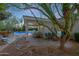 Spacious backyard with a covered patio, outdoor seating, and a pool, perfect for entertaining and relaxation at 9015 E Altadena Ave, Scottsdale, AZ 85260