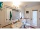 Bathroom featuring a vintage-style sink, toilet, and door to the outside at 9015 E Altadena Ave, Scottsdale, AZ 85260