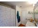 Bathroom featuring a shower with a patterned curtain, toilet, and sink with a large mirror at 9015 E Altadena Ave, Scottsdale, AZ 85260