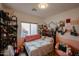 Charming bedroom with a pink accent wall, plenty of decor and lots of natural light at 9015 E Altadena Ave, Scottsdale, AZ 85260