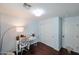 A blue hued bedroom area features dark wood floors and a workstation at 9015 E Altadena Ave, Scottsdale, AZ 85260