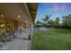 Expansive covered patio with outdoor seating overlooking a lush backyard and swimming pool area at 9015 E Altadena Ave, Scottsdale, AZ 85260